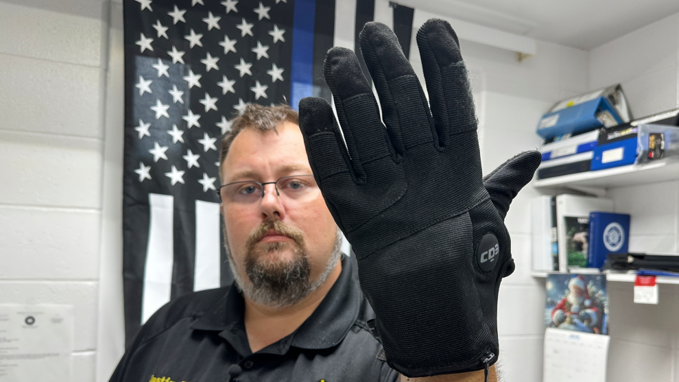 Nelson County, Ky., jailer Justin Hall shows an electric shock glove that is used at his facility,